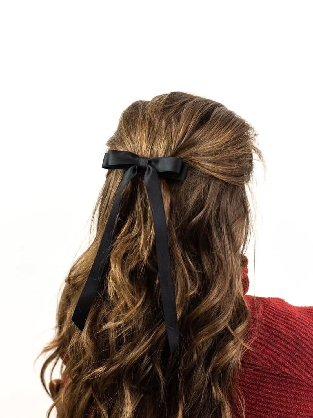Soft half-up style with a tan satin bow